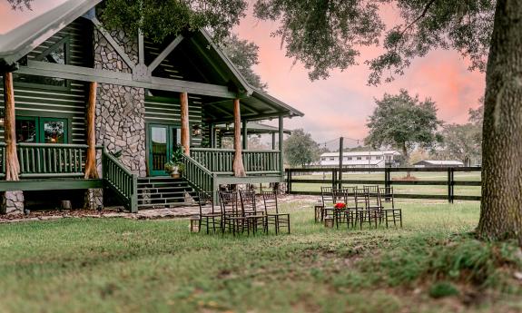 The back yard of the log cabin, with chairs arranged on the lawn