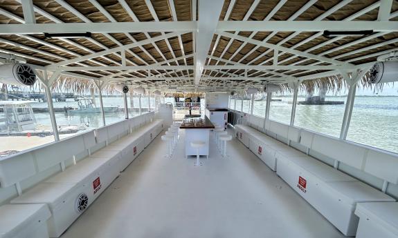 The deck of the "Exosos" pontoon boat, with bench seating, room to stand and dance