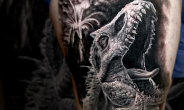 A black and grey dinosaur design by Kevin Moore