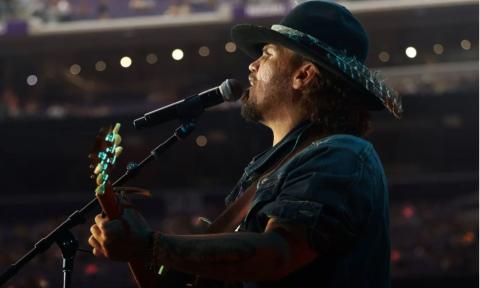 Bryan Martin performs live on stage for fans. 