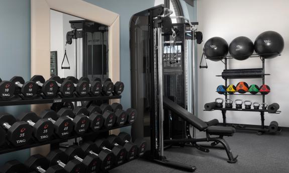 This newly renovated fitness room has weights and a weight bench