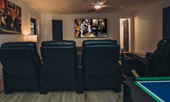 The media room has home theater chairs and several games