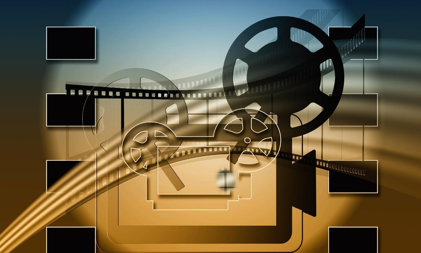 Depiction of movie projector with film over the top of it
