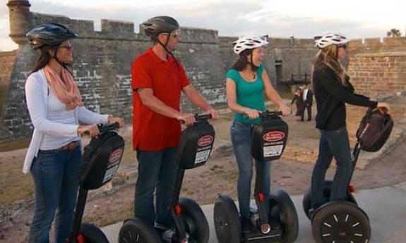 Four tourists on Segways at the Castillo de San Marcos