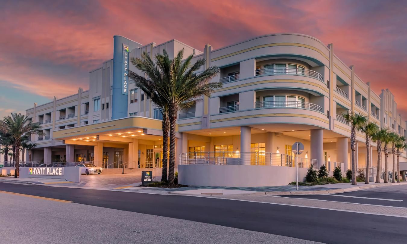 The exterior of Hyatt Place hotel on Vilano against a bright red sunset