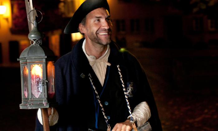 A night watchman with a lantern