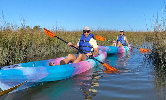 Two people in kayaks exploring the Nocatee marsh