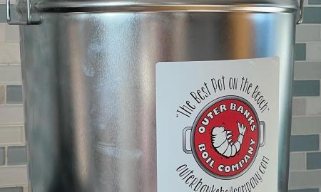 The company's logo is placed on a large steel pot.