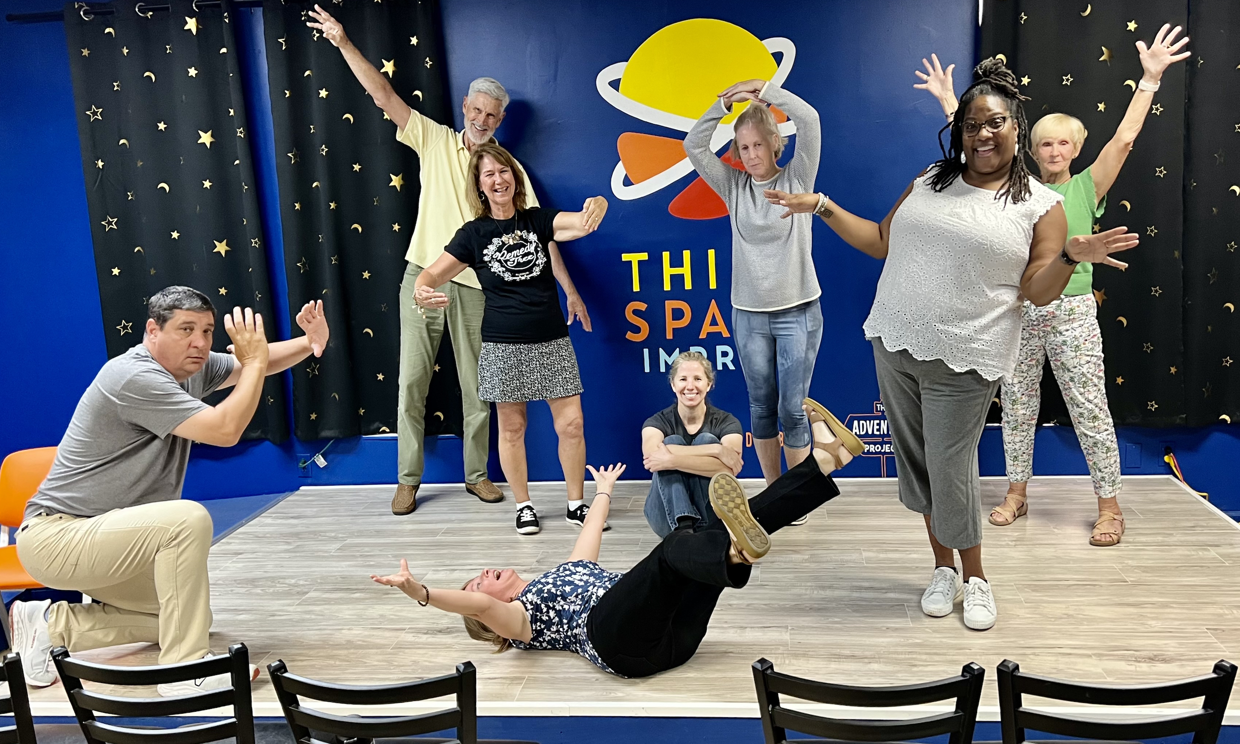 Eight co-workers play an improv game together