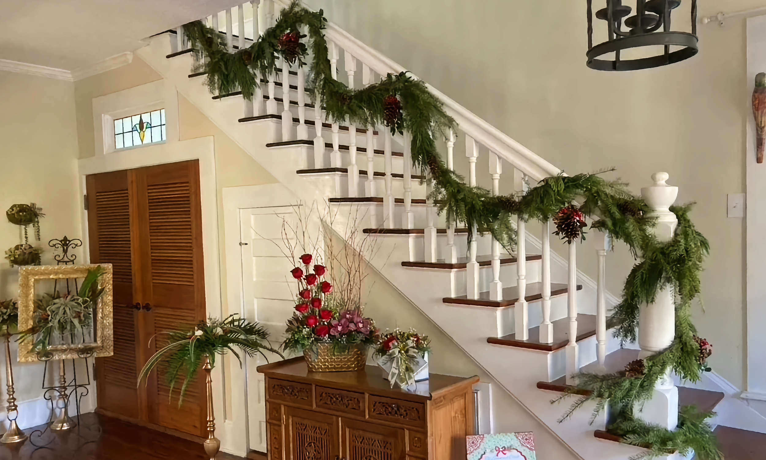 A stairway and entry hall decorated for Christmas