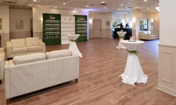 the cocktail area arranged for a wedding, inviting guests to sip and find their seating cards