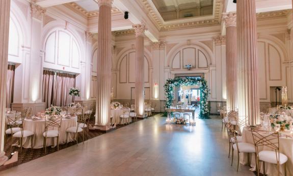 A flower arch greets guests at this reception at the Treasury