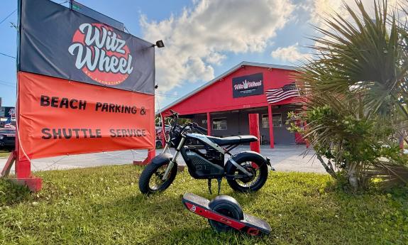 A e-wheel and an electric motorbike near the sign for Witz Wheel